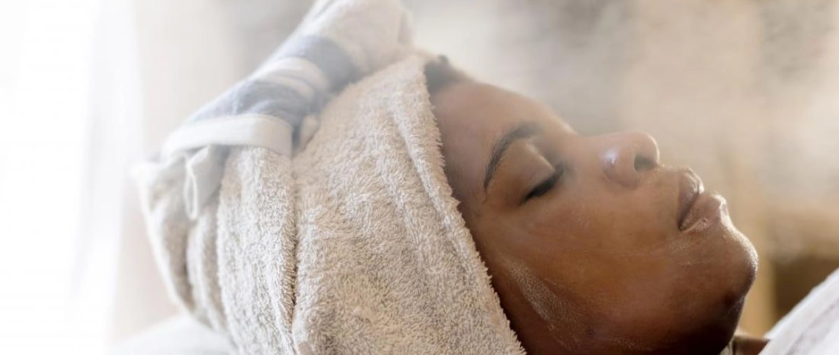 woman-receiving-steam-therapy-spa-treatment-to-improve-facial-skin-min